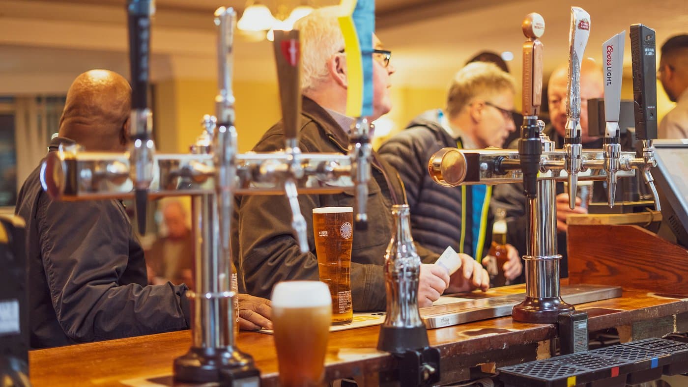 Busy bar scene with beer taps at The New Dun Cow